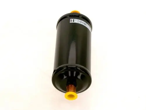Schwarzer Zylinder mit gelben Anschlüssen und einer Kennzeichnung. Dieser Trockenfilter gehört zur Produktlinie von Bosch.